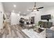 Bright open floorplan of living room and kitchen, featuring hardwood floors and white cabinets at 203 Park Ave, Mount Holly, NC 28120