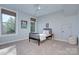 Light-filled bedroom with two windows, neutral carpet, and a stylish black bed frame at 2030 Bosna Ln, Fort Mill, SC 29715
