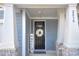 Inviting front entrance features a stylish wreath on the door and brick detailing at 2030 Bosna Ln, Fort Mill, SC 29715