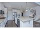 Bright kitchen features a large island, modern appliances, and dark wood flooring at 2030 Bosna Ln, Fort Mill, SC 29715
