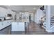 Bright, modern kitchen features a large island, stainless steel appliances, and easy access to the staircase at 2030 Bosna Ln, Fort Mill, SC 29715