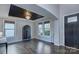 Bright living room features beautiful dark wood floors, two windows, and a tray ceiling at 2030 Bosna Ln, Fort Mill, SC 29715