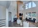 Spacious living room with a grand fireplace, modern light fixture, and tall windows at 2030 Bosna Ln, Fort Mill, SC 29715