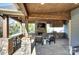 Outdoor kitchen with stone accents, a built-in grill, and a full bar with seating at 2030 Bosna Ln, Fort Mill, SC 29715
