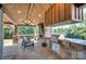 Outdoor kitchen showcasing a stone fireplace, stainless steel grill, and covered patio at 2030 Bosna Ln, Fort Mill, SC 29715