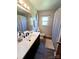 Well-lit bathroom with a vanity, decorative mirror, and a shower with decorative curtains at 205 Cooke Cir, Kings Mountain, NC 28086
