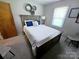 Bright bedroom with modern decor, featuring a comfortable bed, natural light, and stylish accent pieces at 205 Cooke Cir, Kings Mountain, NC 28086