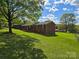 Brick home with manicured lawn and mature trees, showcasing its serene and inviting exterior at 205 Cooke Cir, Kings Mountain, NC 28086