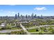 Scenic aerial view of a city skyline, lush green trees, and a highway with flowing traffic at 210 Walford Dr, Charlotte, NC 28208