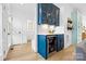 Chic bar area with blue cabinetry, a wine cooler, and a sink, perfect for entertaining guests at 210 Walford Dr, Charlotte, NC 28208