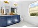 Stylish bathroom with blue vanity, double sinks, and window view at 210 Walford Dr, Charlotte, NC 28208