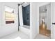 Modern bathroom featuring dark tile, bathtub, and bright window at 210 Walford Dr, Charlotte, NC 28208