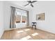 Minimalist bedroom with hardwood floors, large window, and simple decor at 210 Walford Dr, Charlotte, NC 28208