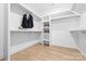Spacious walk-in closet with custom shelving and wood floors, offering ample storage at 210 Walford Dr, Charlotte, NC 28208