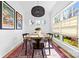 Sunlit dining room with modern chandelier, vintage posters, and light-filled windows at 210 Walford Dr, Charlotte, NC 28208