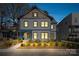 Charming two-story home with blue trim, a cozy front porch, and well-maintained landscaping at 210 Walford Dr, Charlotte, NC 28208