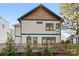 Charming exterior featuring white siding, blue trim, yellow-framed windows, and a fenced yard at 210 Walford Dr, Charlotte, NC 28208