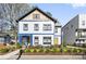 Charming two-story home featuring colorful accents, a welcoming porch, and fresh landscaping at 210 Walford Dr, Charlotte, NC 28208