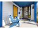 Inviting front porch with blue chair, decorative plants, and stylish entrance door at 210 Walford Dr, Charlotte, NC 28208