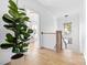 Hallway with a view of a Bedroom and an adjacent staircase, featuring hardwood floors and white walls at 210 Walford Dr, Charlotte, NC 28208