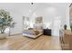 Bright primary bedroom with vaulted ceiling, neutral tones, hardwood floors, and a luxurious en suite bathroom at 210 Walford Dr, Charlotte, NC 28208