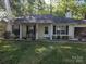 Charming single-story home with rocking chairs on the front porch and well-maintained landscaping at 2213 Wheaton Way, Monroe, NC 28112