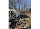 An exterior view of a neglected home with trash and debris scattered around the yard at 2504 Windswept Way, Rockwell, NC 28138