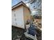 The exterior of a dilapidated home displays peeling paint and various discarded items scattered nearby at 2504 Windswept Way, Rockwell, NC 28138