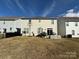 View of the backyard, with a small patio area, a basketball hoop, and grassy space at 3042 Burnello Ct, Iron Station, NC 28080