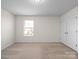 A bedroom features neutral carpet, double closets and a bright window at 3042 Burnello Ct, Iron Station, NC 28080