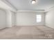 Bright bedroom with neutral carpet, trim and tray ceiling features one large window with blinds at 3042 Burnello Ct, Iron Station, NC 28080