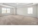 Bright bedroom with neutral carpet, trim and tray ceiling features two large windows with blinds at 3042 Burnello Ct, Iron Station, NC 28080