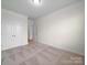 Bedroom features neutral carpet, trim, and double closet doors; a light-filled and versatile space at 3042 Burnello Ct, Iron Station, NC 28080
