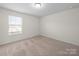 A well-lit bedroom with carpeted floors and a window to provide natural light at 3042 Burnello Ct, Iron Station, NC 28080