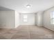 Spacious bedroom with neutral carpet, trim, and two large windows letting in ample natural light at 3042 Burnello Ct, Iron Station, NC 28080