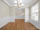 Open dining area featuring wood floors, classic trim, and a modern light fixture at 3042 Burnello Ct, Iron Station, NC 28080