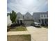 Traditional two-story home boasts a two-car garage, covered porch, and a well-manicured lawn at 3042 Burnello Ct, Iron Station, NC 28080