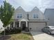 Charming two-story home features a covered porch, two-car garage, and well-maintained landscaping at 3042 Burnello Ct, Iron Station, NC 28080