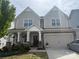 Charming two-story home features a covered porch, two-car garage, and well-maintained landscaping at 3042 Burnello Ct, Iron Station, NC 28080