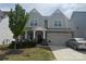 Charming two-story home features a covered porch, two-car garage, and well-maintained landscaping at 3042 Burnello Ct, Iron Station, NC 28080