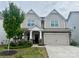 Charming two-story home with a well-maintained lawn, stone accents, and an attached two-car garage at 3042 Burnello Ct, Iron Station, NC 28080