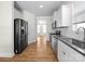 Modern kitchen with stainless steel appliances, granite countertops, and white cabinets at 3042 Burnello Ct, Iron Station, NC 28080