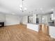 Spacious living area with kitchen island, fireplace, and hardwood floors at 3042 Burnello Ct, Iron Station, NC 28080