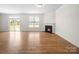 Open living space featuring a fireplace, backyard access, and natural light at 3042 Burnello Ct, Iron Station, NC 28080