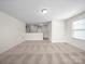 Spacious living room with neutral carpet and trim features a large window and an open floorplan at 3042 Burnello Ct, Iron Station, NC 28080