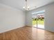 Well-lit living room with a sliding glass door offering a view of the landscaped backyard at 3042 Burnello Ct, Iron Station, NC 28080