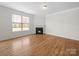 Bright living room with a fireplace and large window, perfect for relaxation and entertaining at 3042 Burnello Ct, Iron Station, NC 28080