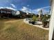 Cozy patio area featuring outdoor seating, landscaping, and a partial view of the grassy backyard at 3042 Burnello Ct, Iron Station, NC 28080