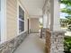 Covered front porch featuring brick pillars, a concrete floor, and exterior siding at 3042 Burnello Ct, Iron Station, NC 28080