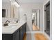 Modern bathroom boasts a double vanity with dark cabinets and a marble countertop with updated mirrors at 315 Arlington Ave # 506 & 507, Charlotte, NC 28203